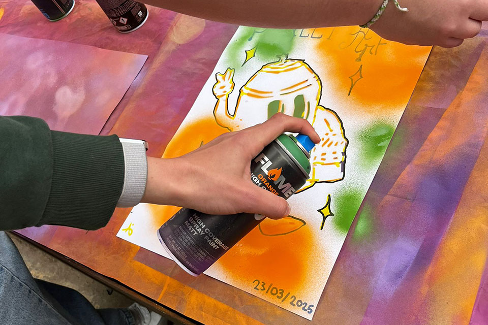 young artists painting with spray cans