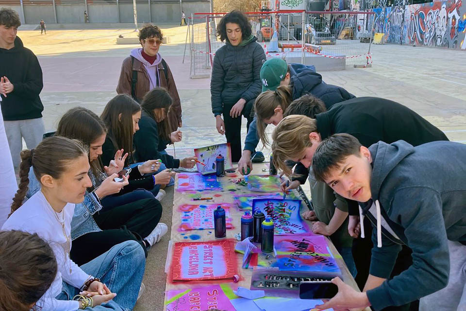 group of students painting with spray cans and markers