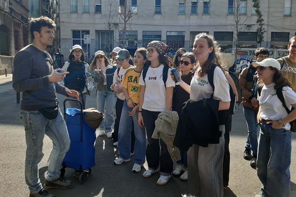 teenagers listening to a guide during the educational school trip in Barcelona