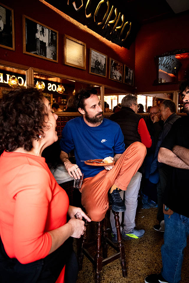 enjoying tapas at a bar with a professional