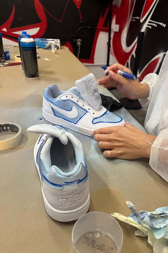 painting nike shoes after the street art tour